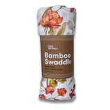 Bamboo swaddle blanket with floral pattern and brown label on a white background